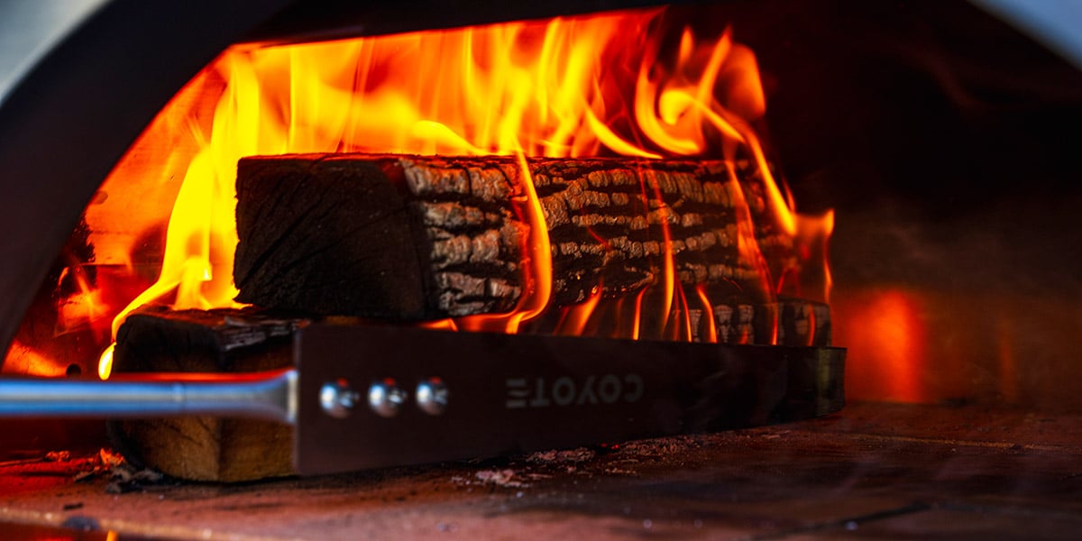 logs on fire in pizza oven