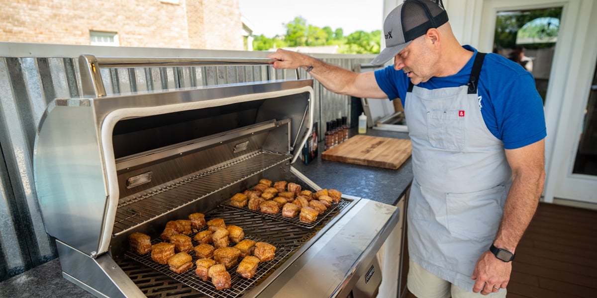 man barbecuing with the best pellet smoker