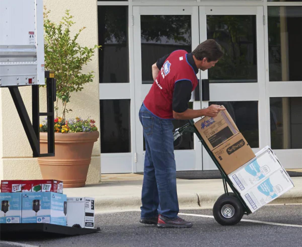 man unloading truck with lowes order