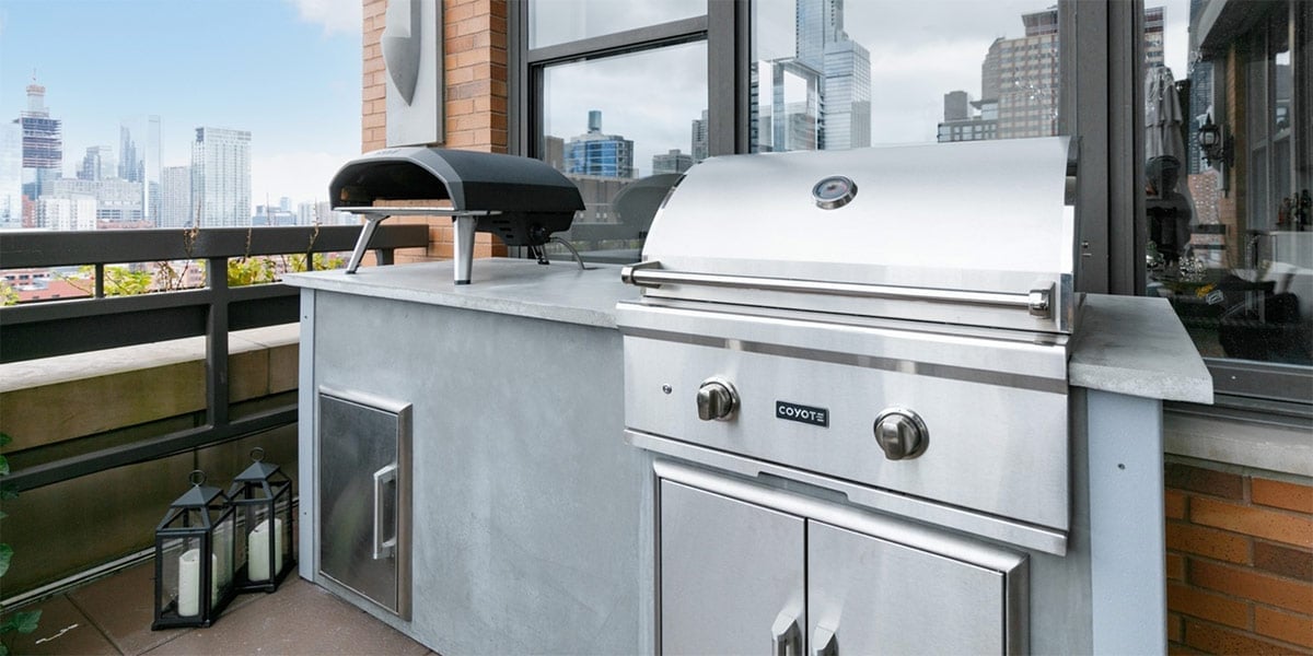 modern concrete outdoor kitchen with ooni pizza oven