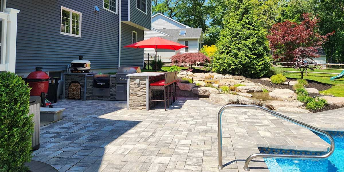 modern outdoor area with outdoor kitchen and water feature
