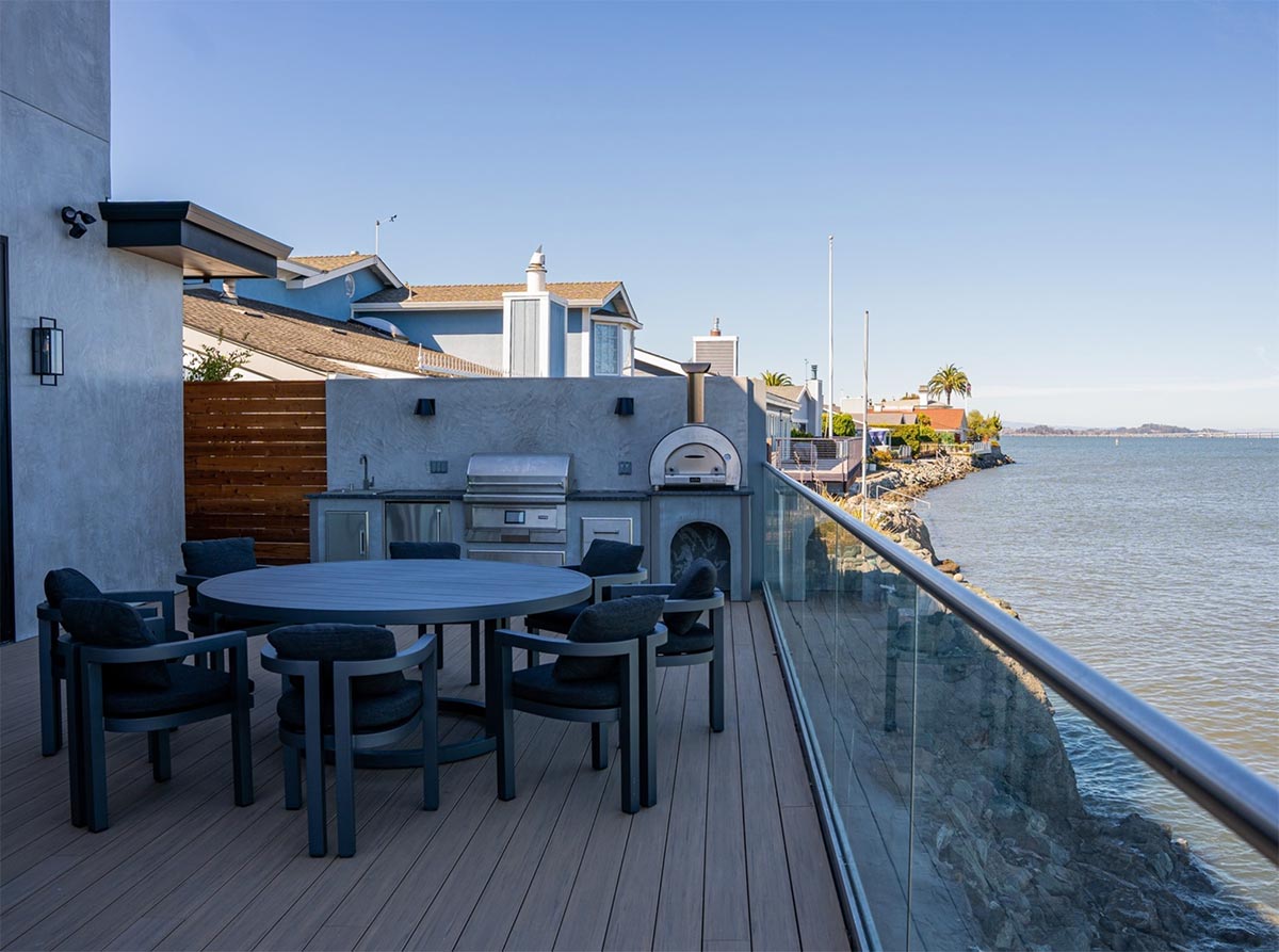 modern outdoor dining table by linear outdoor kitchen on deck