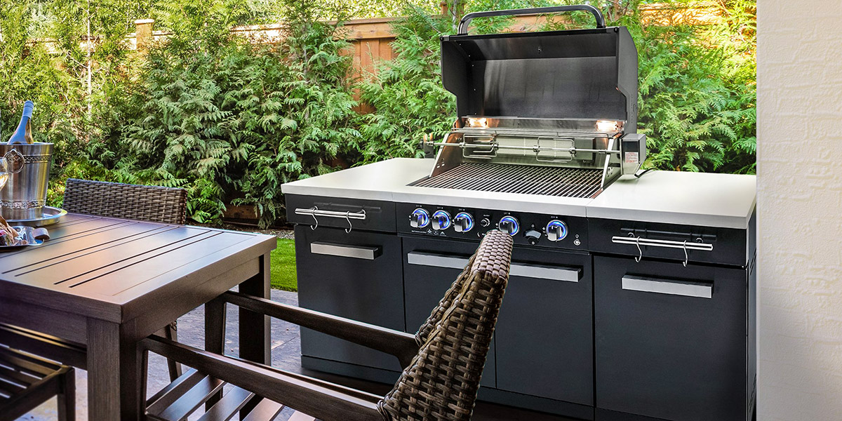 mont alpi outdoor kitchen grill on patio with dining table