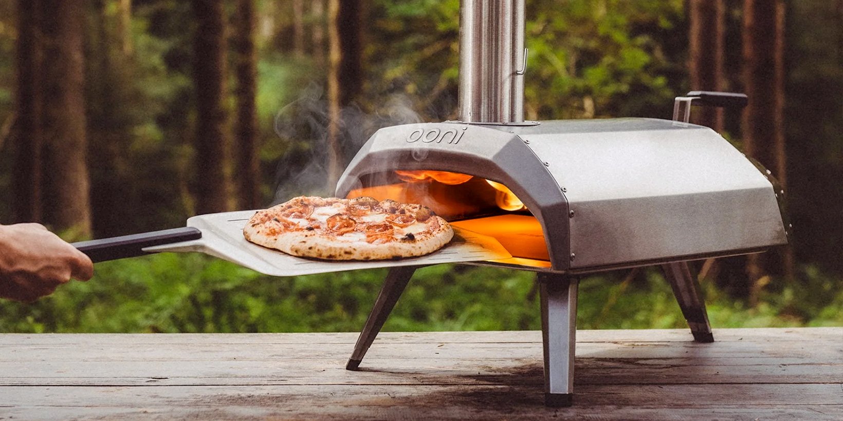 ooni pizza oven on tabletop with cooked pizza