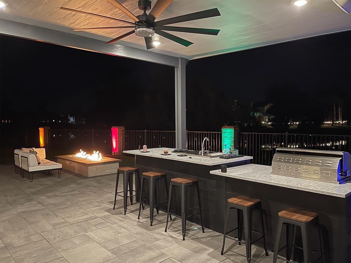 outdoor bar area at night with fire pit