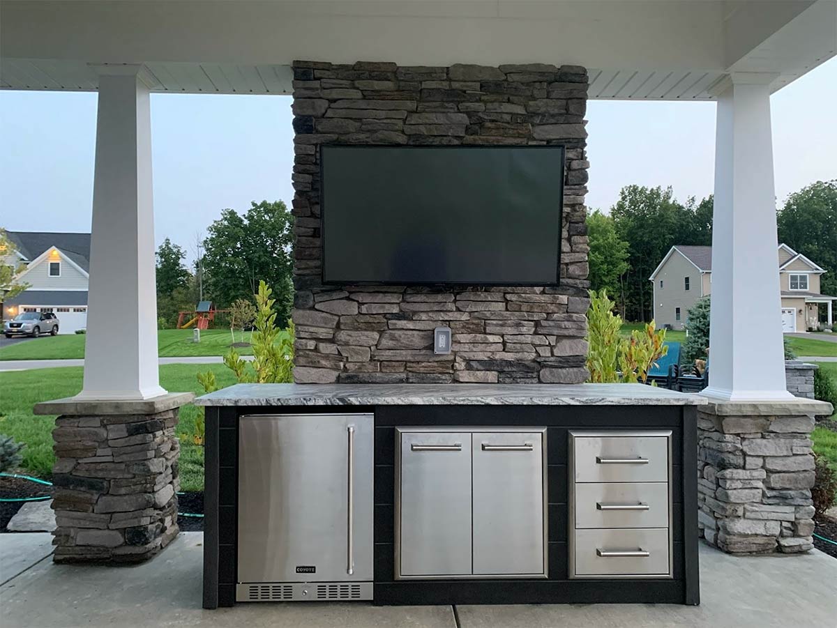 outdoor bar island with refrigerator and tv above
