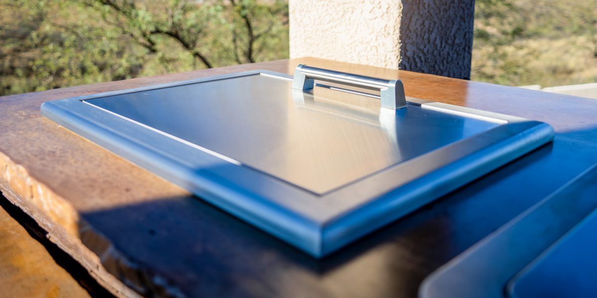 outdoor cooler set inside outdoor kitchen countertop