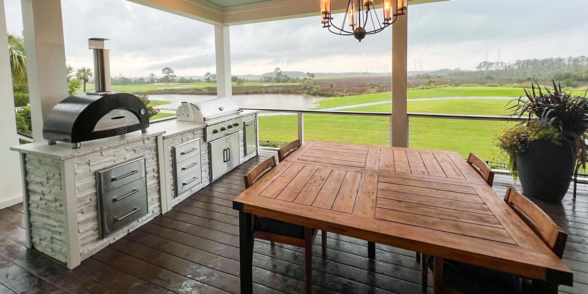 outdoor covered kitchen ideas with dining table and chandelier