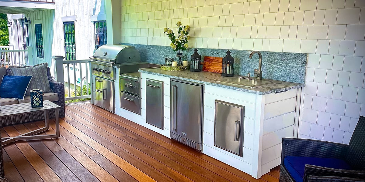 outdoor covered kitchen on deck with white plank finish