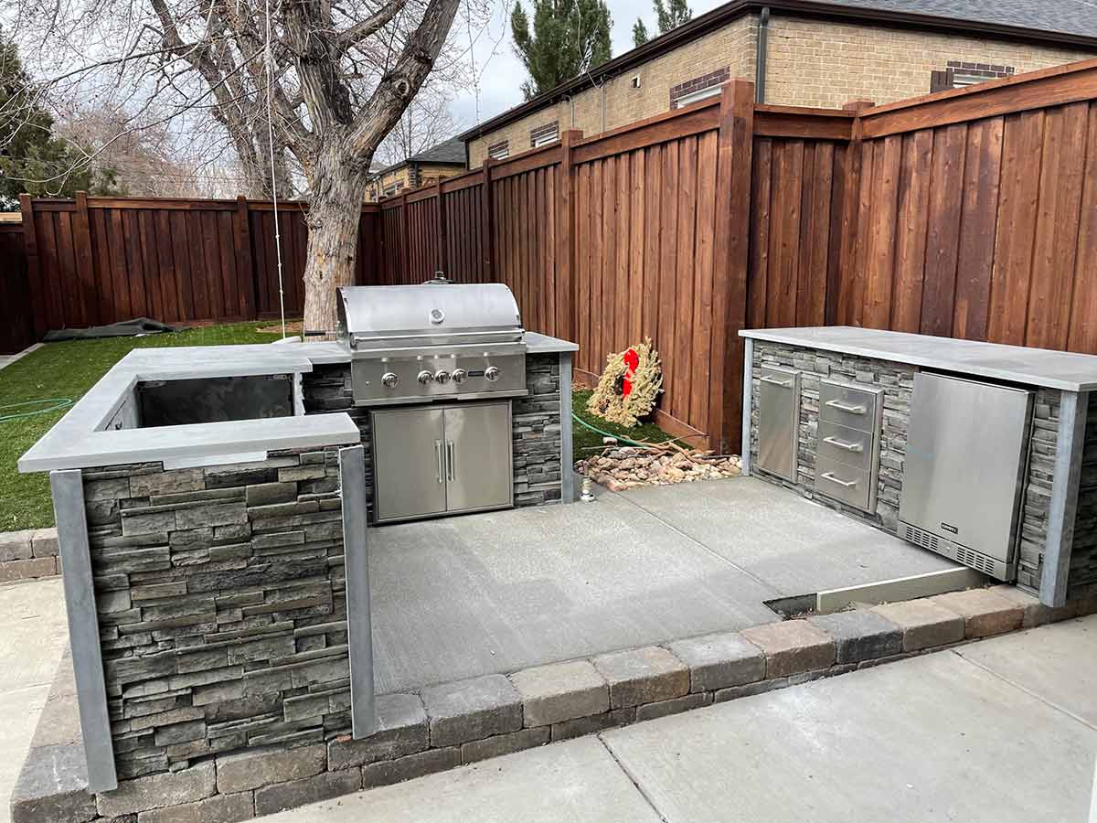 outdoor kitchen built on a raised section of patio