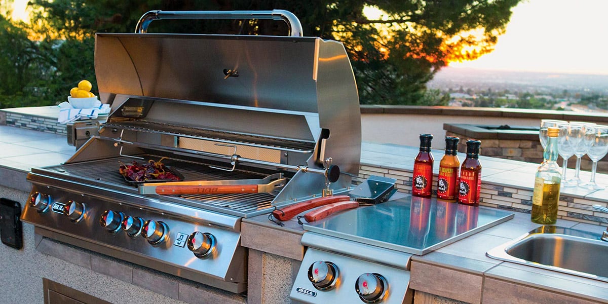 outdoor kitchen close up with condiments and grill