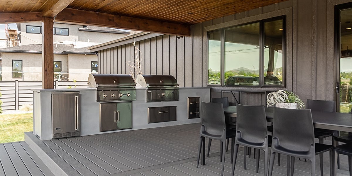 outdoor kitchen deck with black dining table