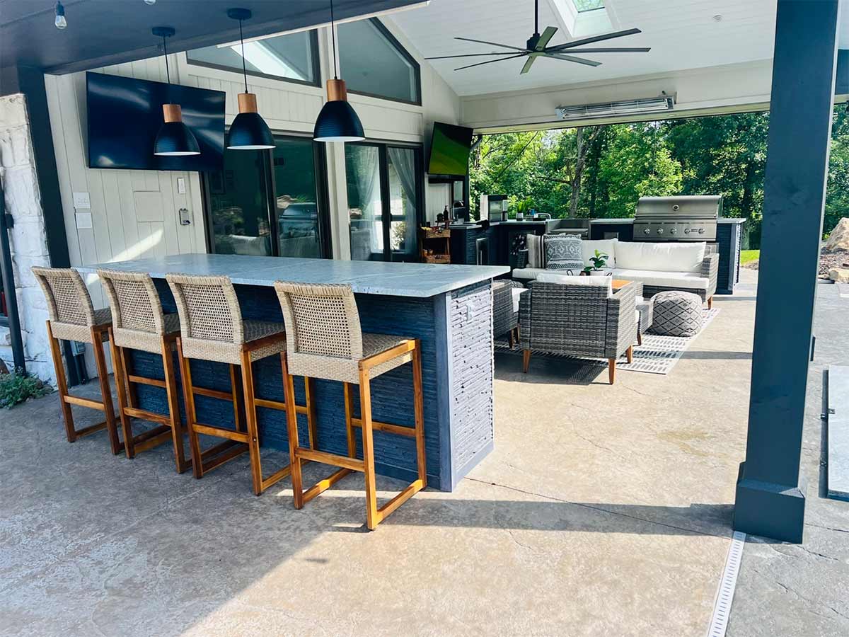 outdoor kitchen ideas with grill island and separate bar island with chairs