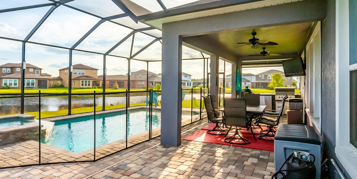 outdoor kitchen in florida room with pool