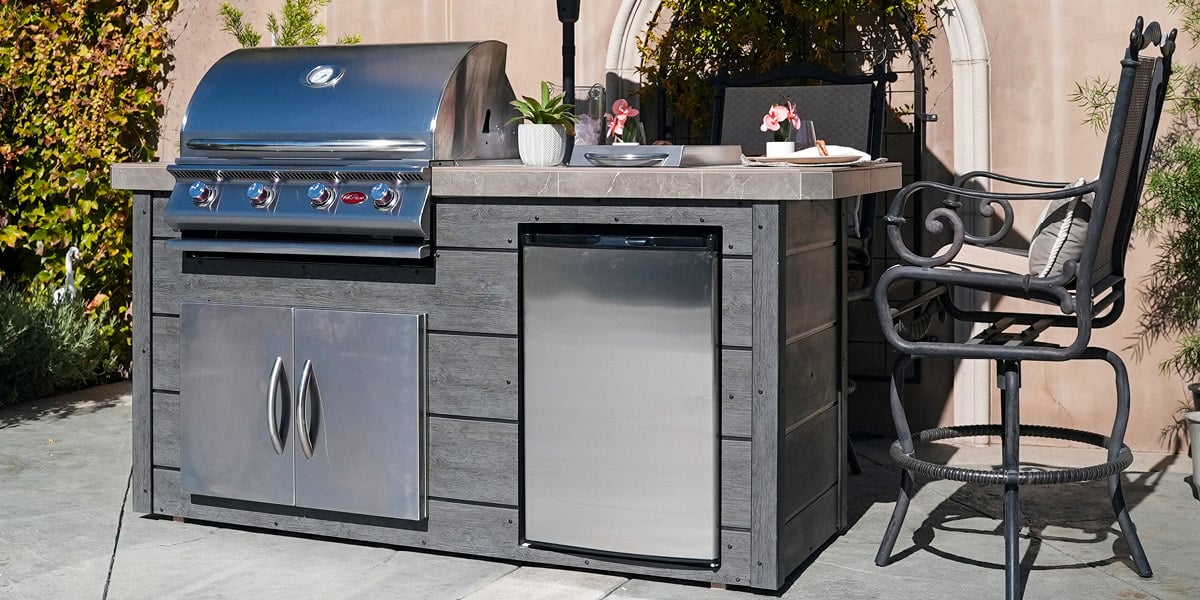 outdoor kitchen island with grill and patio chair