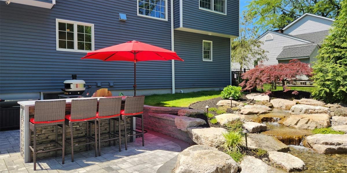 outdoor kitchen next to water feature