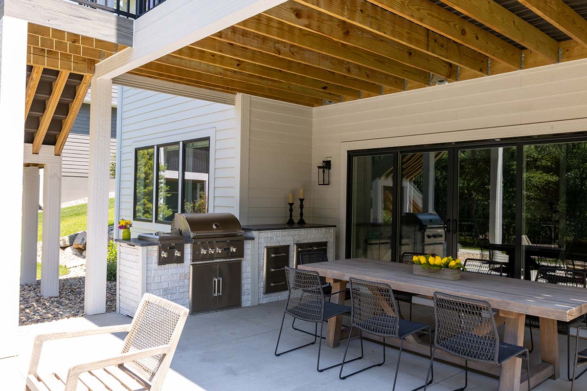 outdoor kitchen on patio with dining room table