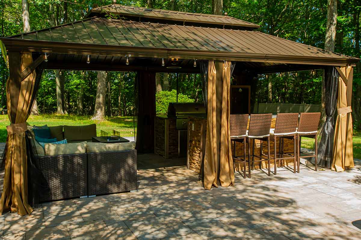 The Best Outdoor Pavilion with Kitchen Solution featuring an outdoor kitchen under cover in a woods setting