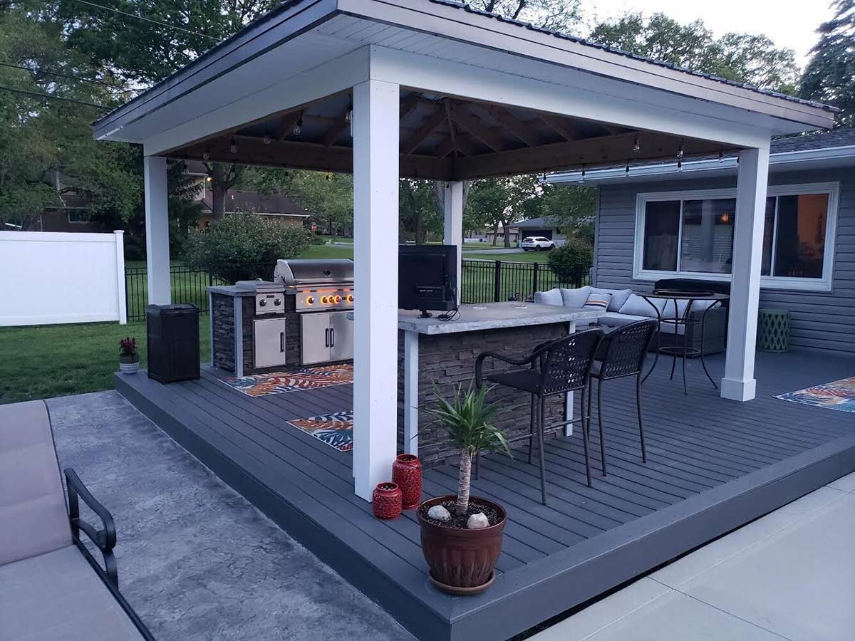 outdoor kitchen with bar seating for entertainment