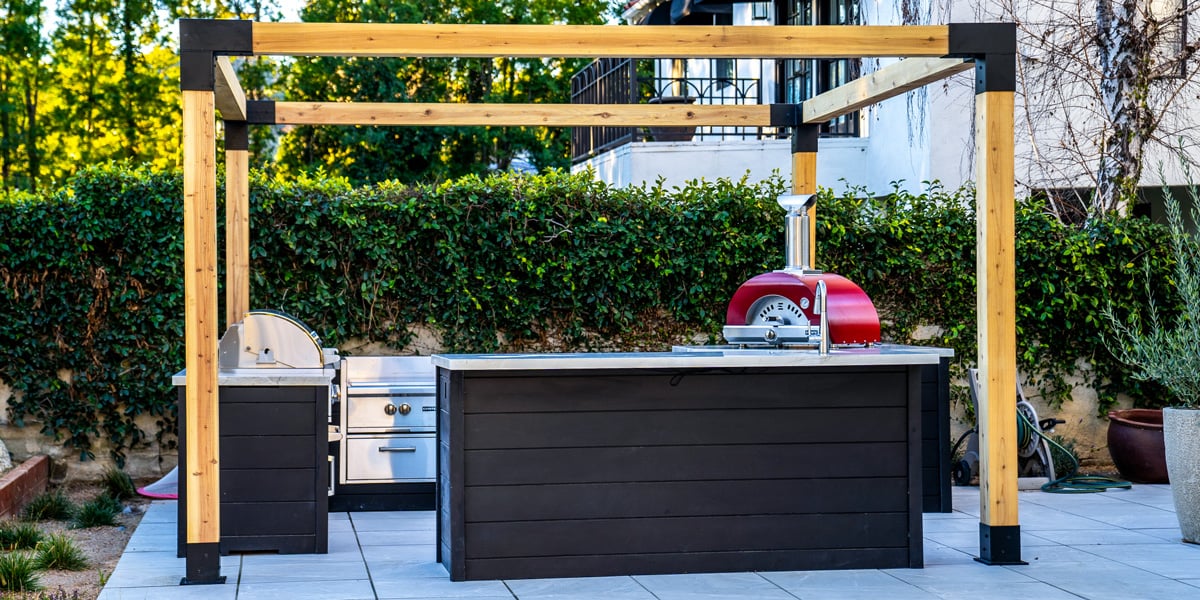 outdoor kitchen with pizza oven on corner island