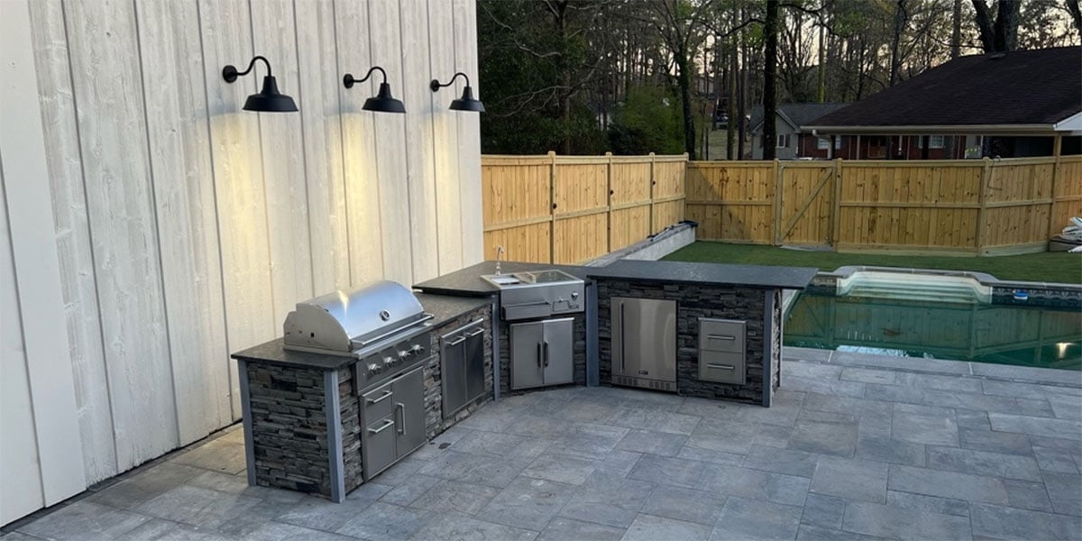 outdoor lighting on wall above l shape outdoor kitchen