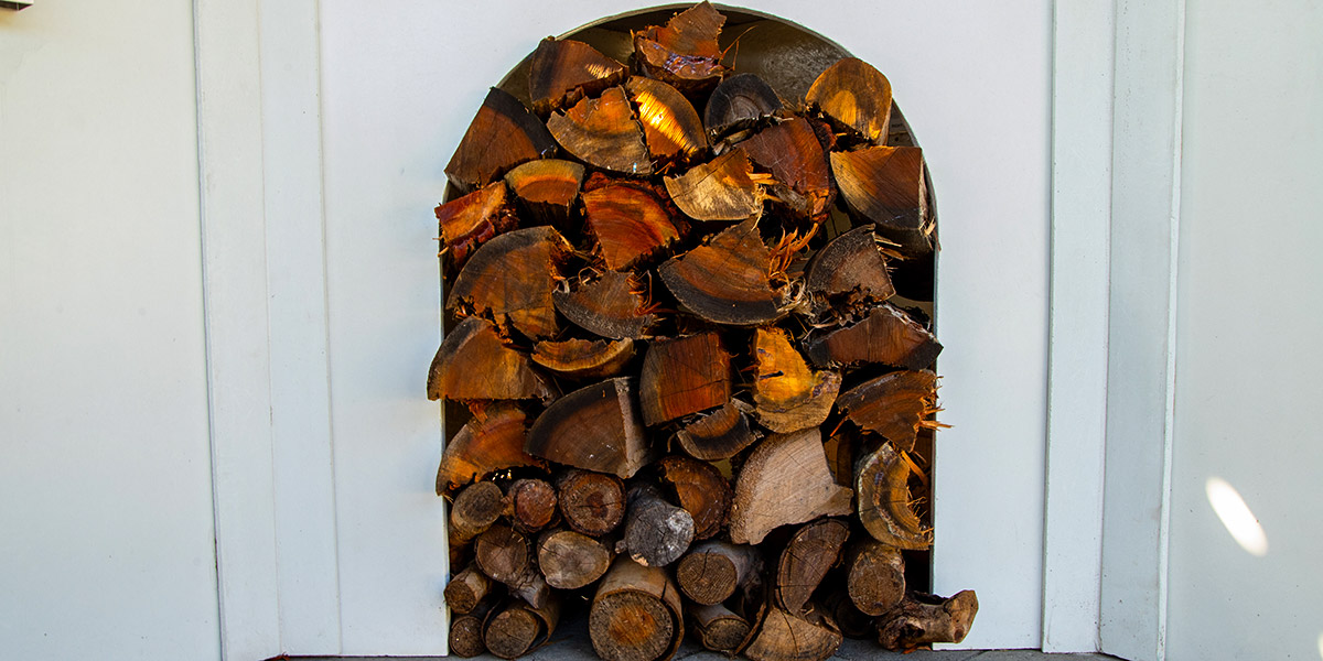 outdoor pizza oven wood stacked in island