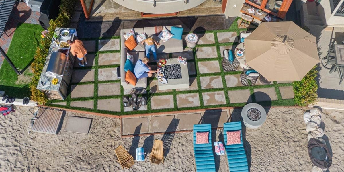 Overhead of outdoor living space with linear grill island on the beach.