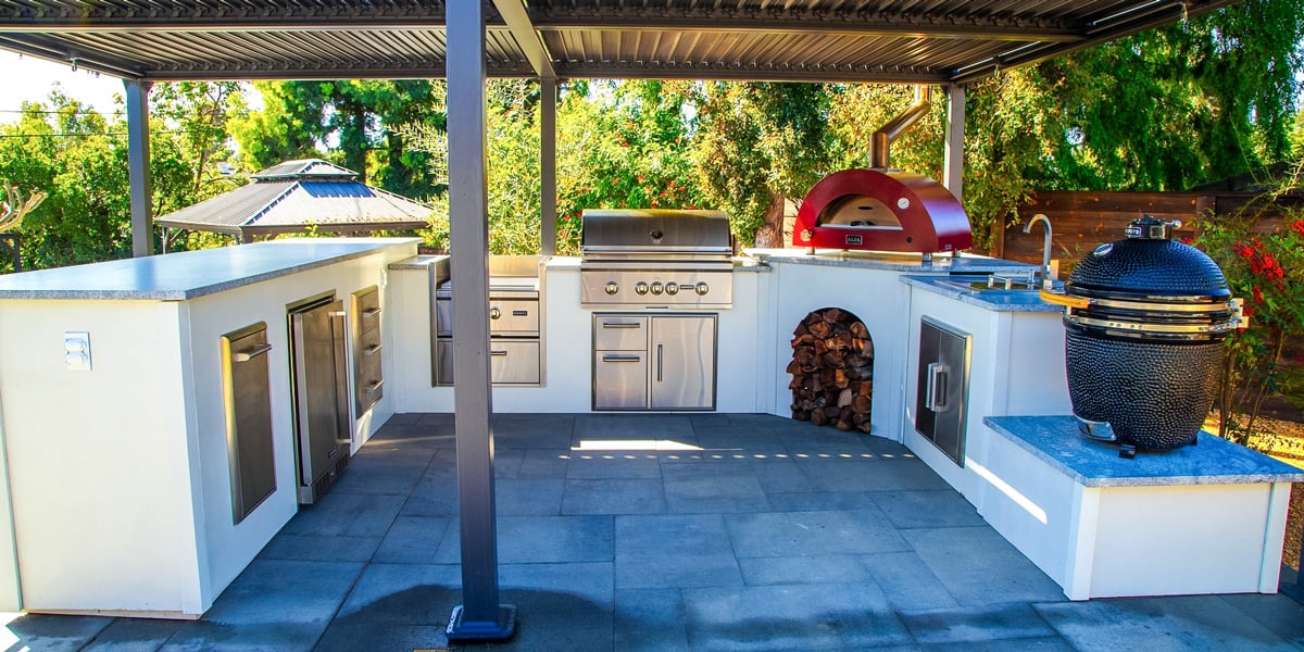 patio grill island with modern concrete finish and pizza oven