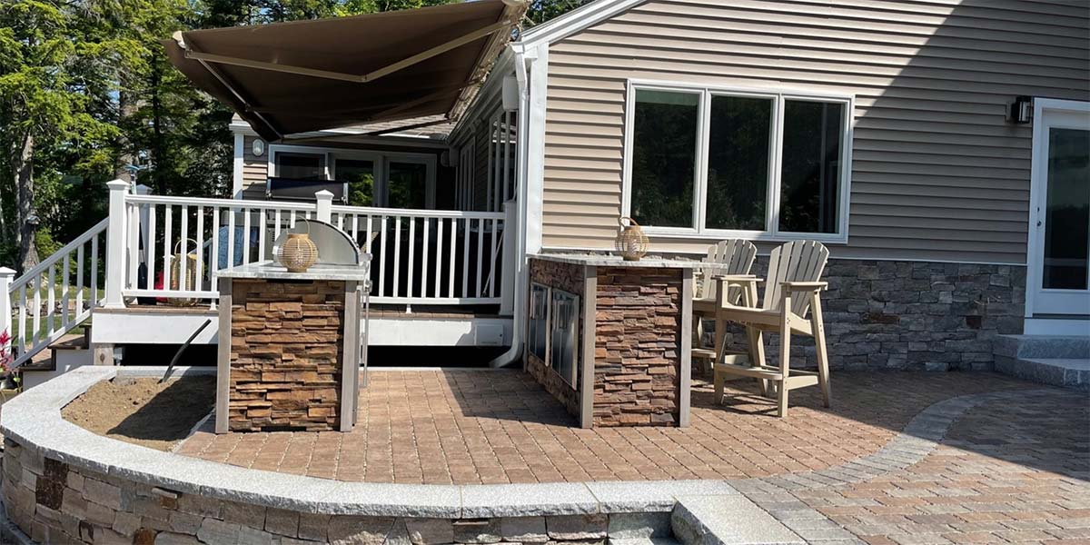 patio with galley style outdoor kitchen with bar island