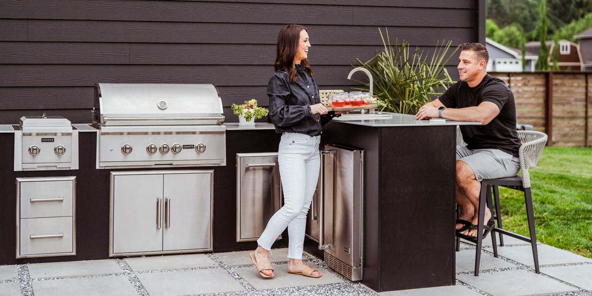 people enjoying cooking on their built in grill and outdoor kitchen that has industry leading durability
