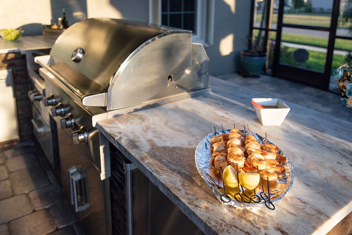 plated shrimp skewers on counter of outdoor kitchen