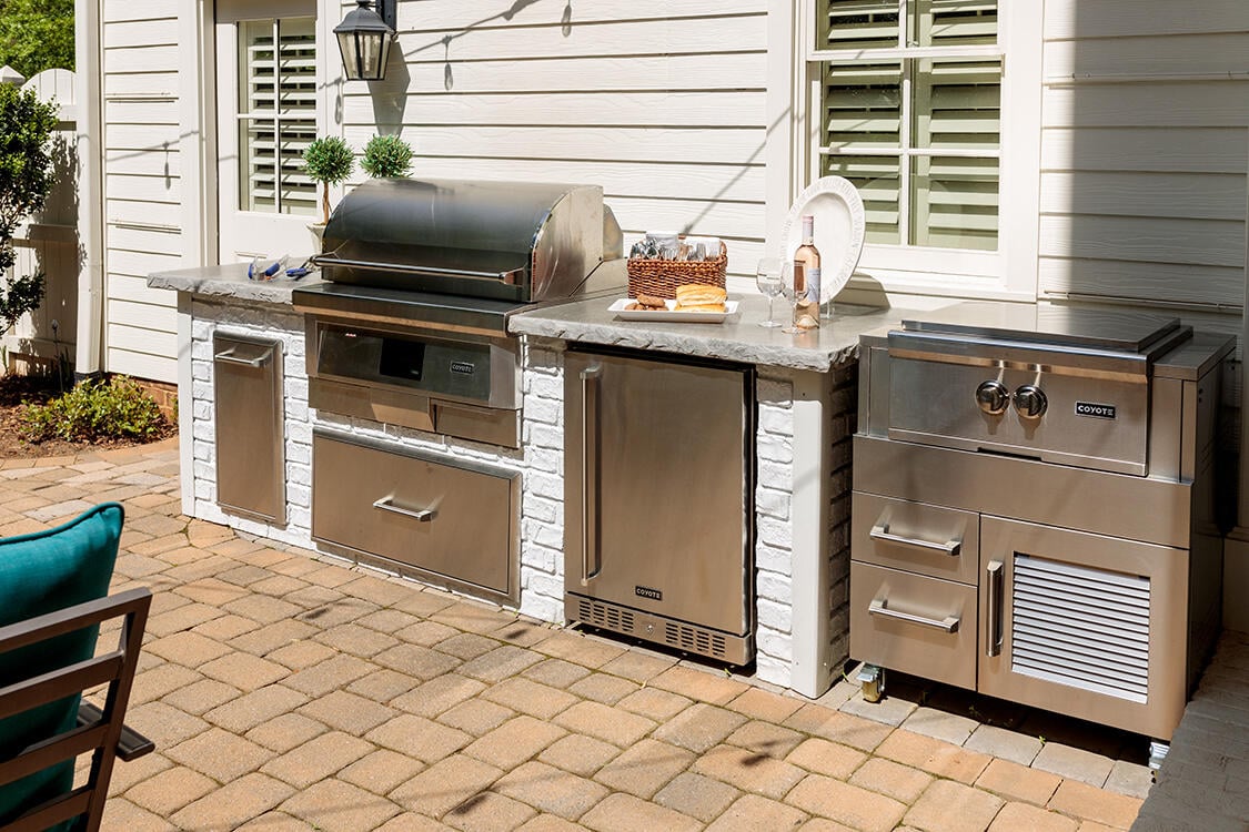 reclaimed brick outdoor kitchen on patio with built in pellet grill