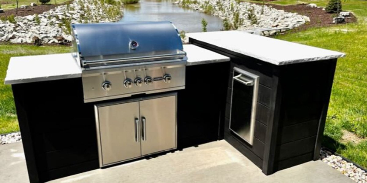 rta l shaped outdoor kitchen in plank finish with coyote grill storage and trash receptacle