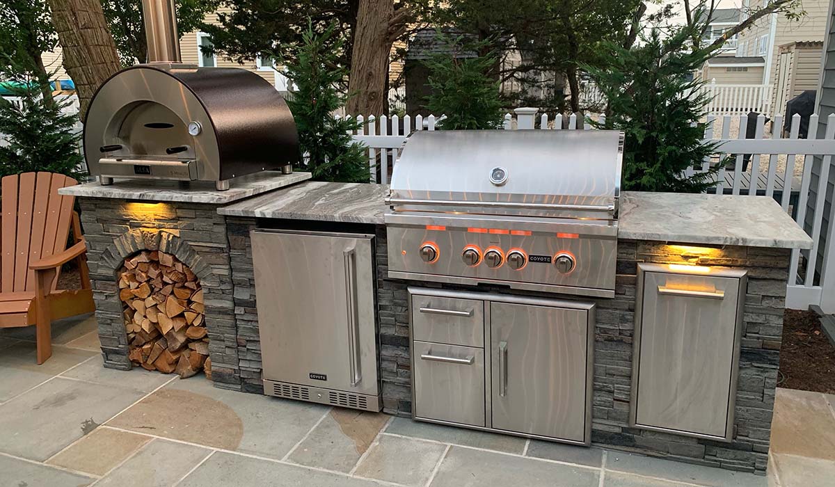 rta outdoor kitchen with a stacked stone finish and granite countertop in nj