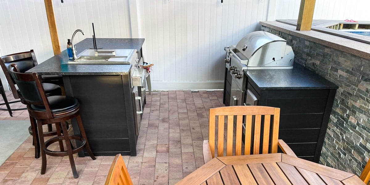 small galley outdoor kitchen with gas grill and sink refreshment center