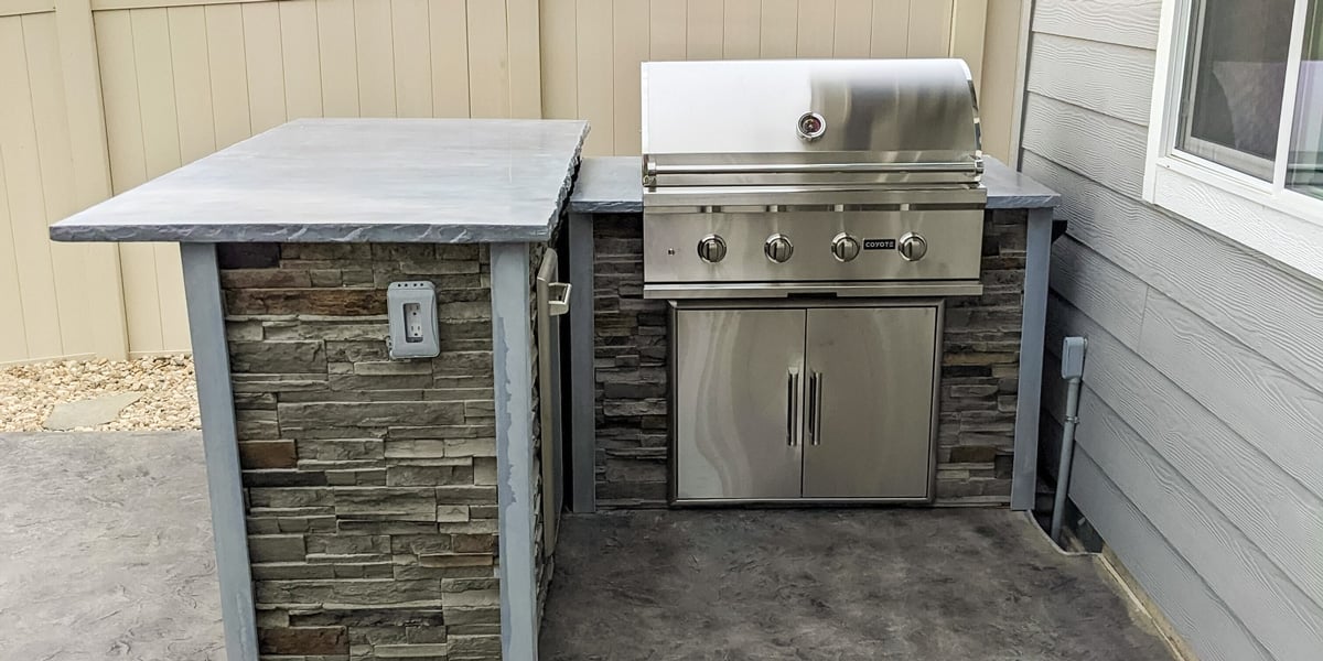 small l shaped outdoor kitchen near exterior wall of home