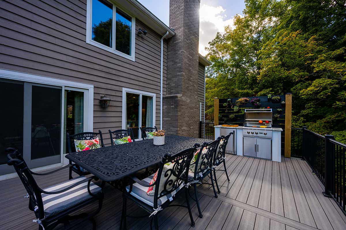 small linear outdoor kitchen on deck by dining table