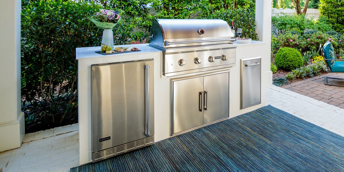 a moks modular outdoor kitchen in modern white finish on a patio