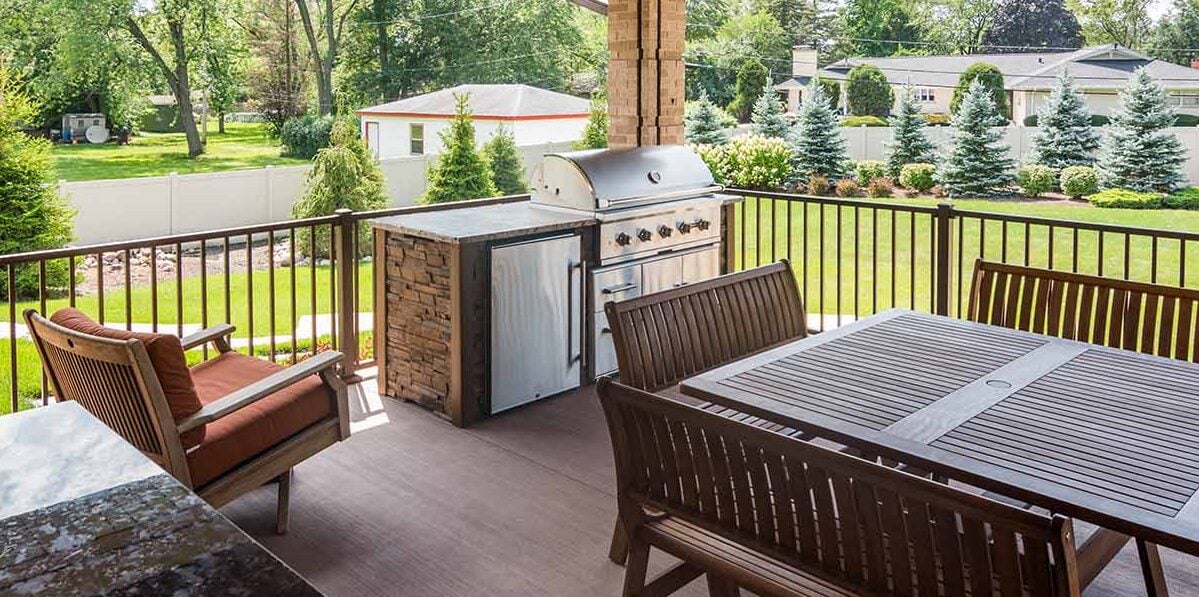 small stone outdoor kitchen on a covered deck