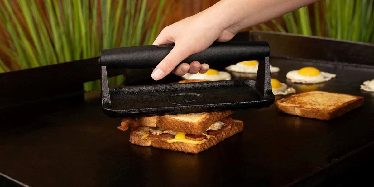 someone grilling a breakfast sandwich on carbon steel griddle