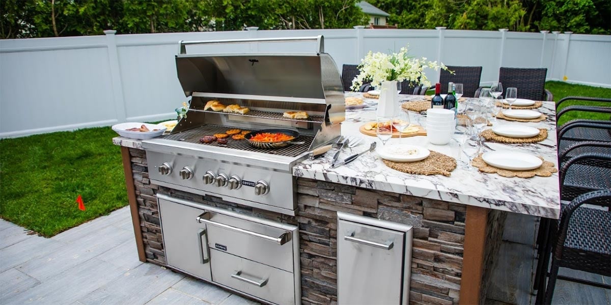 square outdoor kitchen idea in yard with gas grill and granite countertops