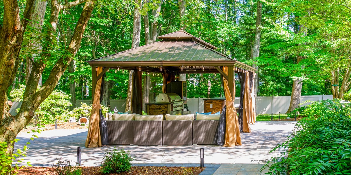 square pavilion in lush green backyard