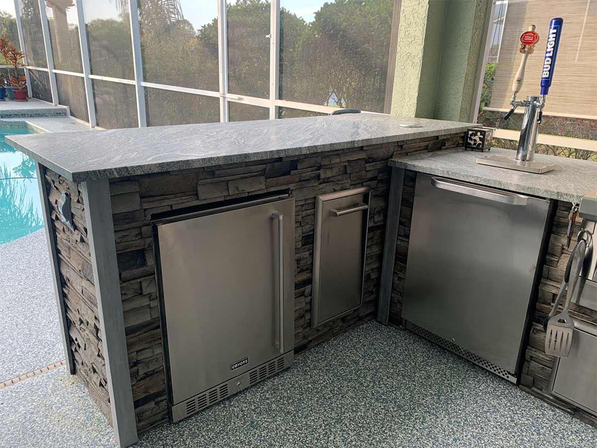 stacked stone graphite bar island with refrigerator and trash and kegerator