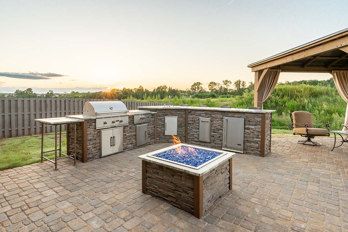 stacked stone outdoor kitchen with power burner and gas grill
