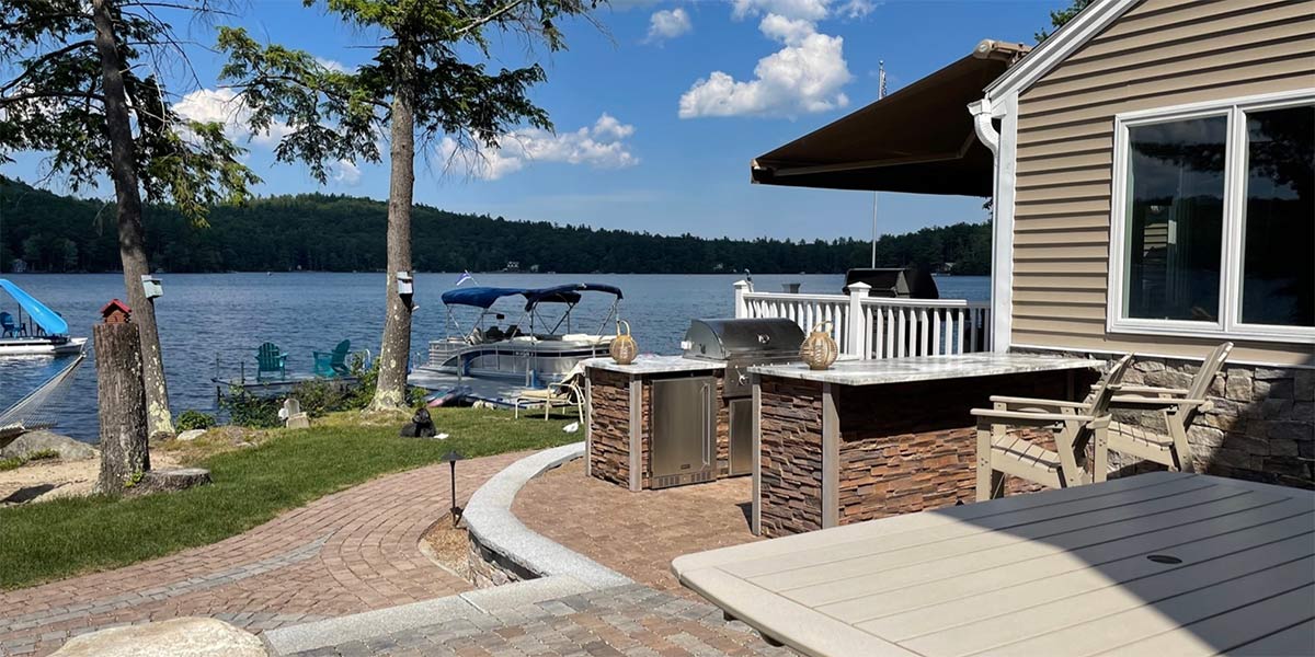 stone galley outdoor kitchen with lakeside view