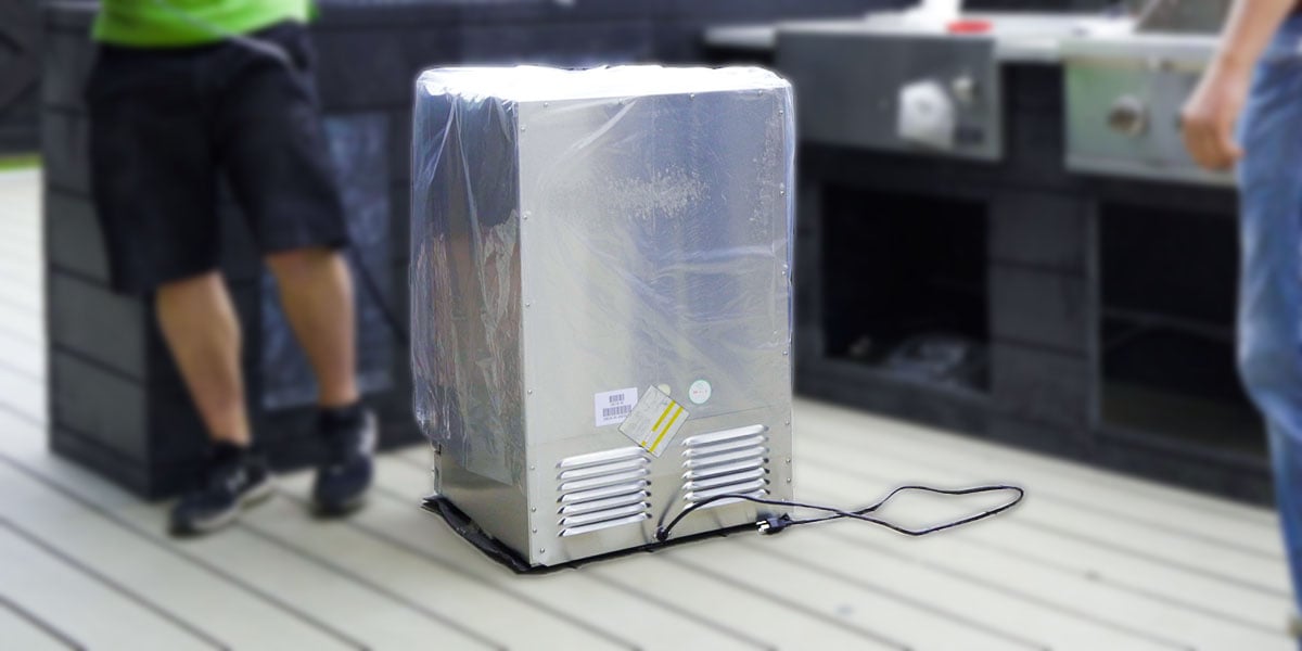 the back of a brand new coyote outdoor refrigerator showing the electrical cord