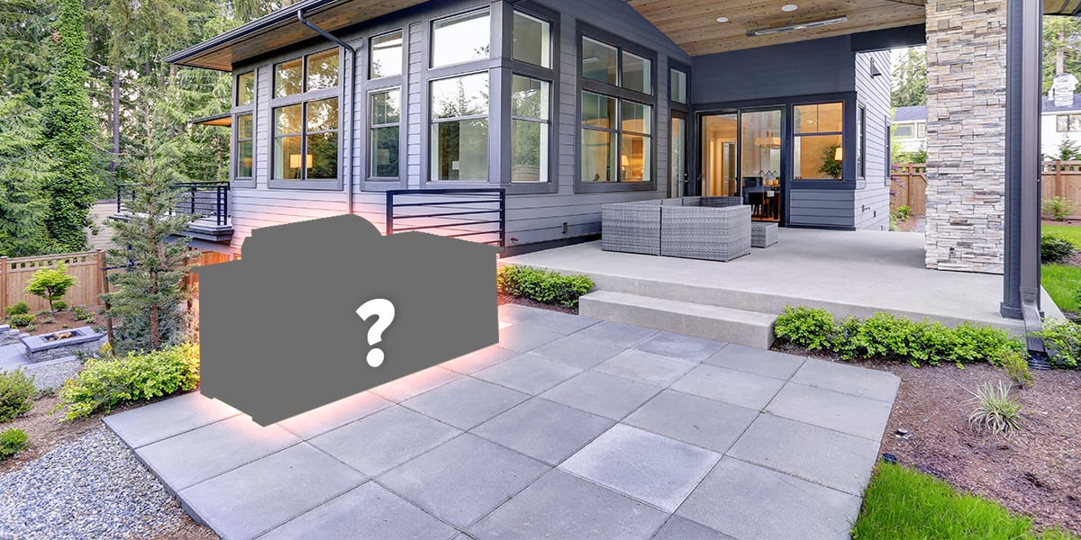 Backyard with a silhouetted modular outdoor kitchen with a question mark