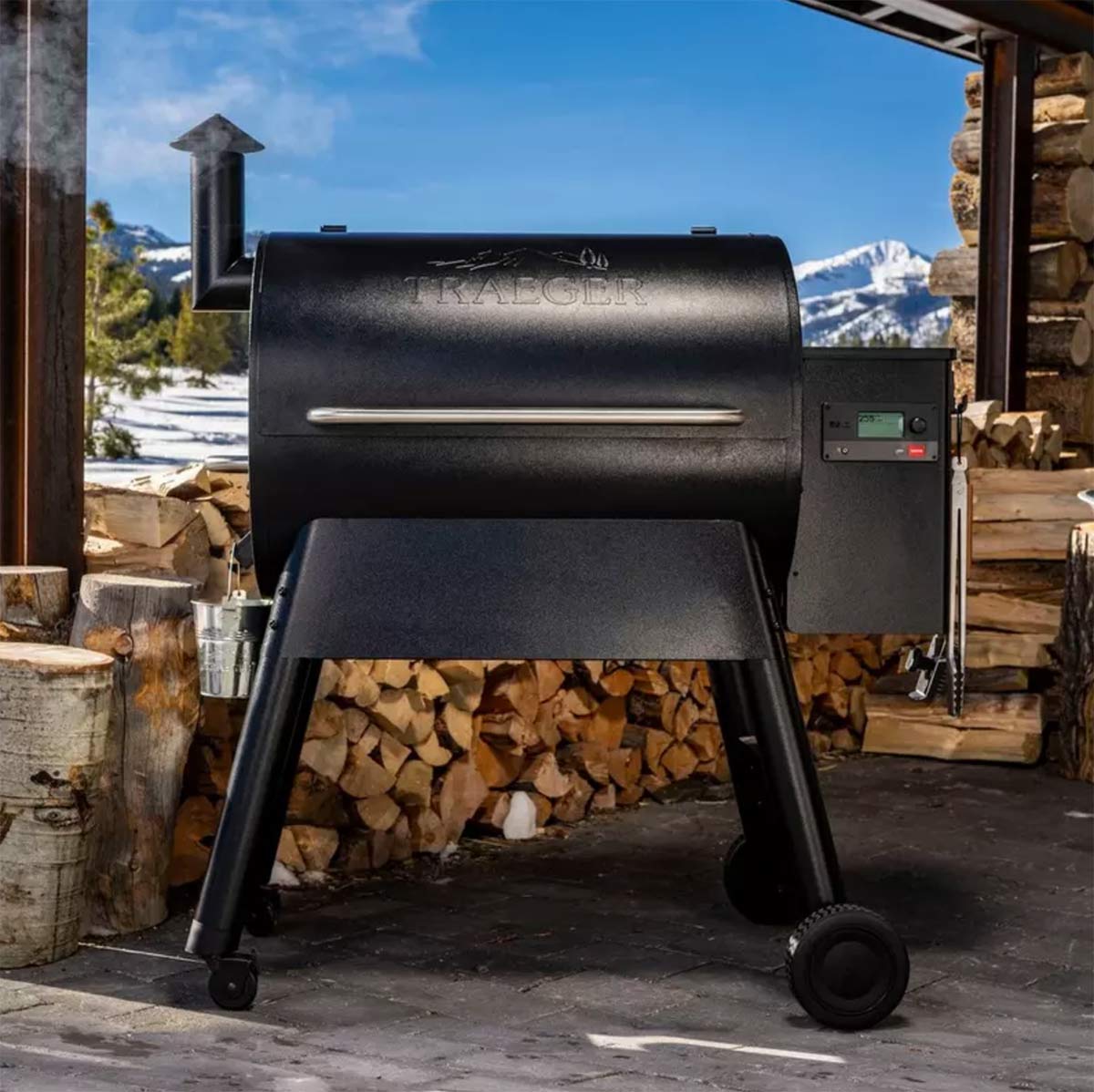 traeger pro 780 in front of wood pile