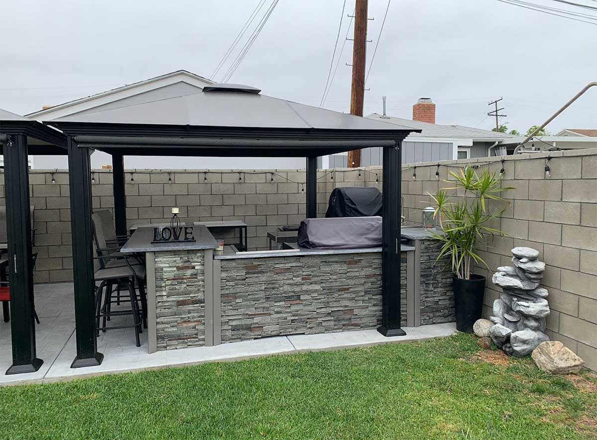 Covered outdoor kitchen and bar idea with string lights