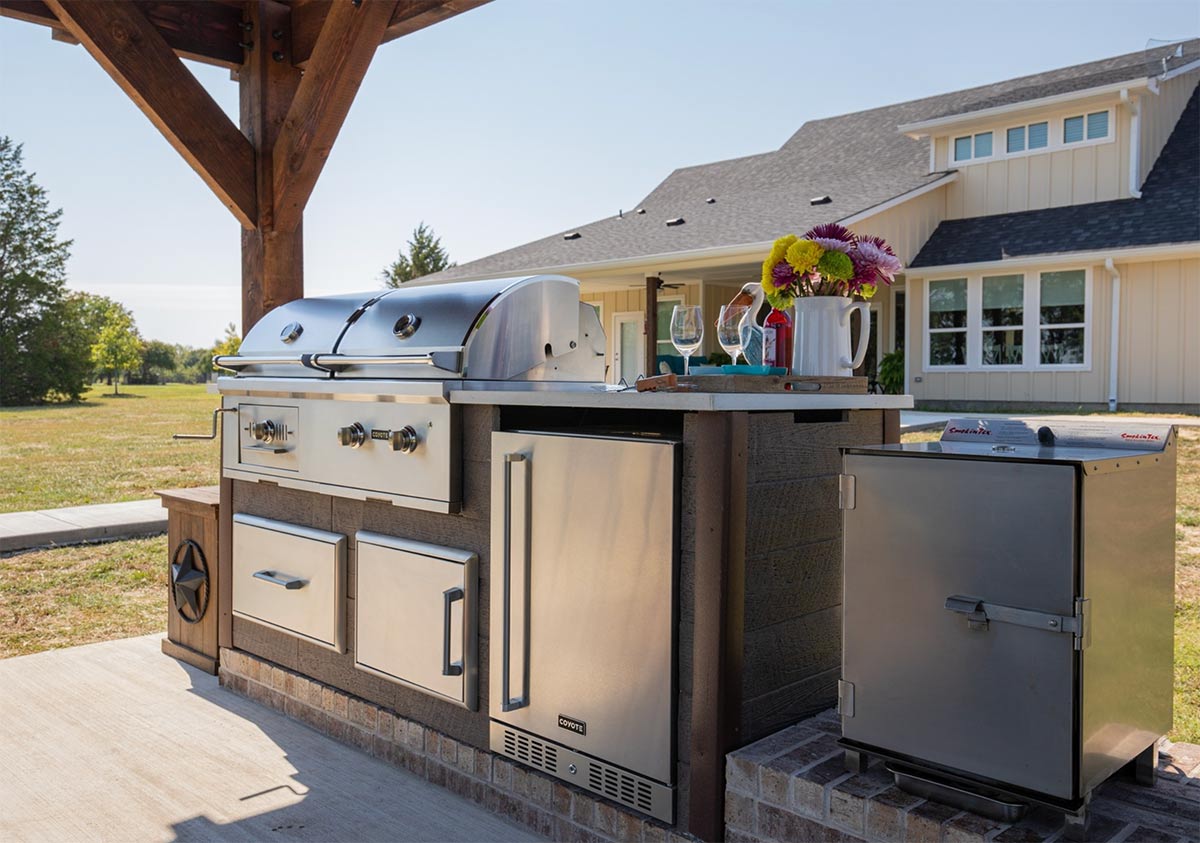 weathered wood outdoor kitchen with hybrid grill